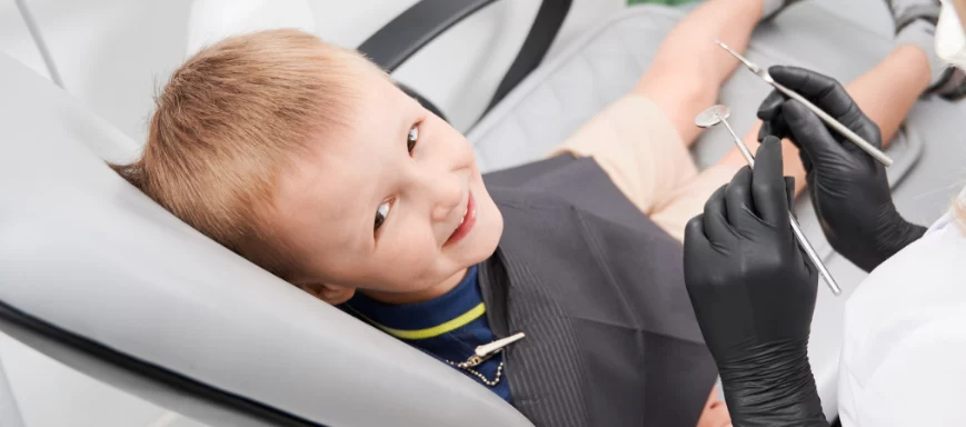 Child sat on dental chair smiling